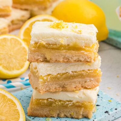 three frosted lemon bars stacked