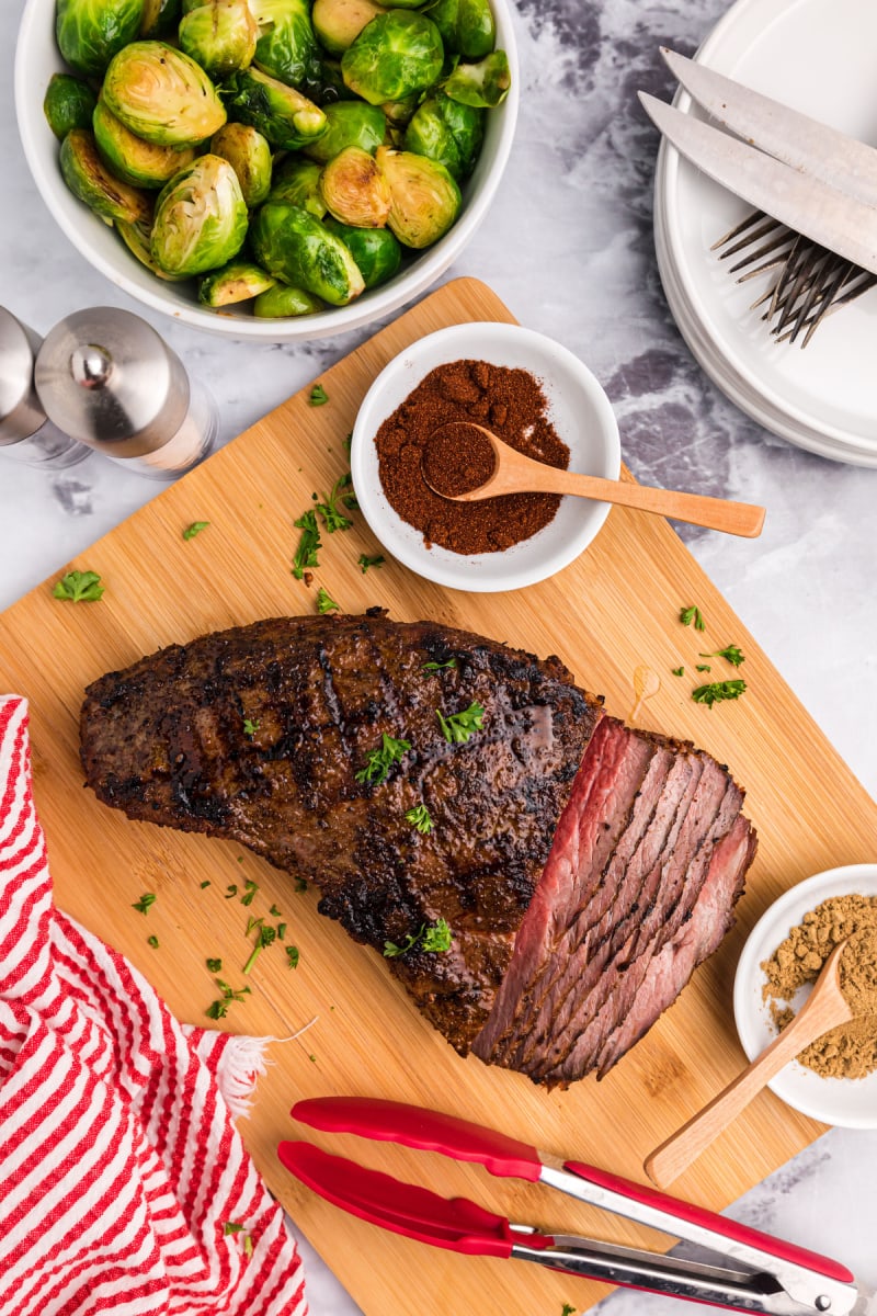 grilled chili garlic tri tip on cutting board part of it sliced