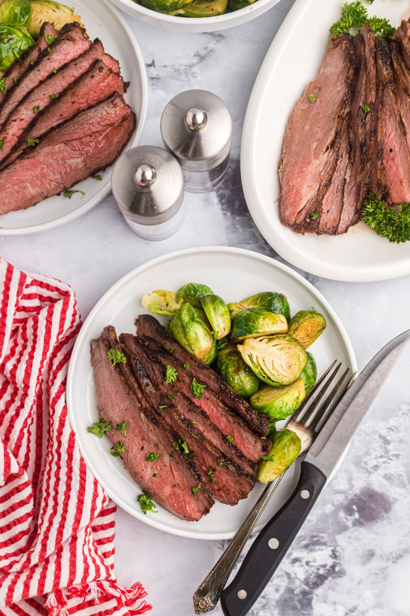 tri tip slices on a plate with brussels sprouts