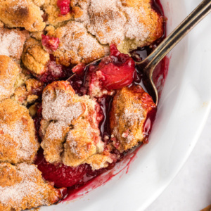 plum cobbler with spoon in it