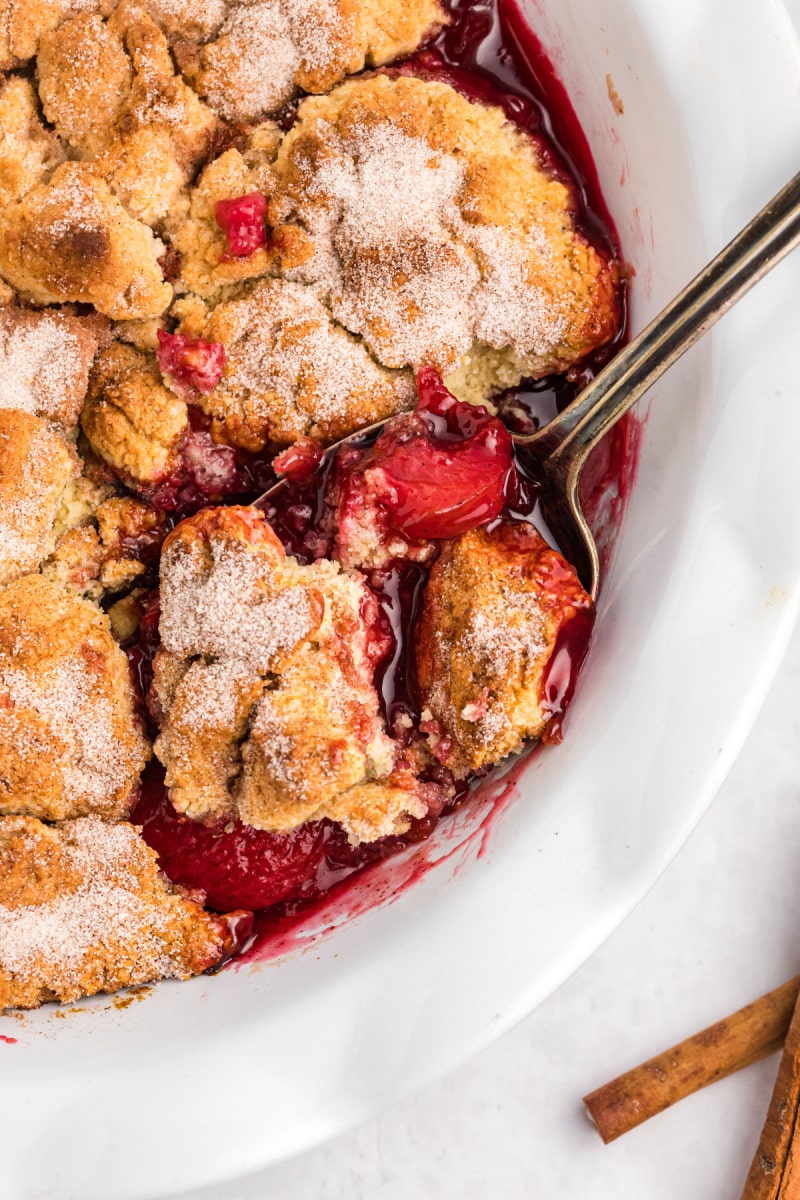 plum cobbler with spoon in it