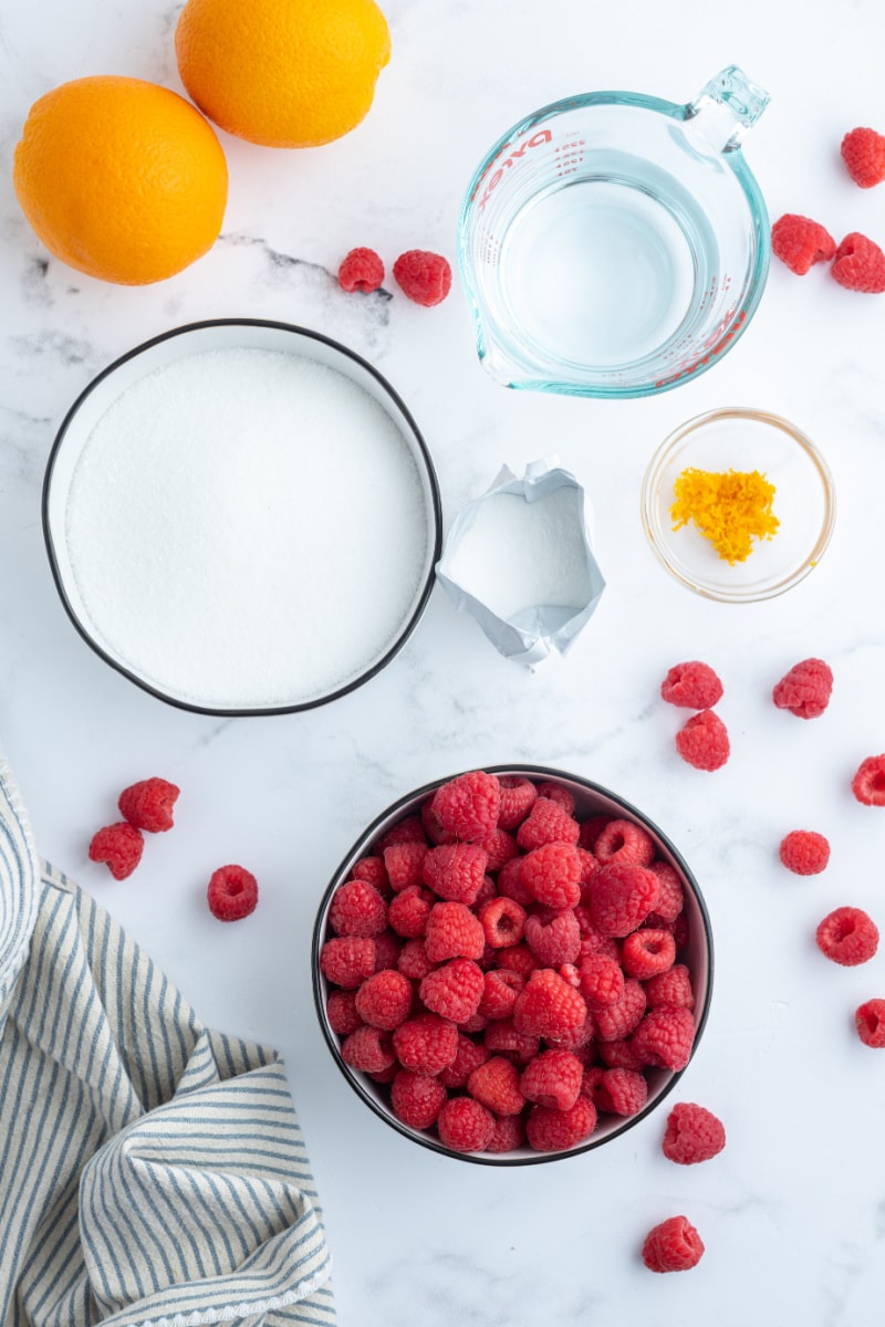 ingredients displayed for making raspberry orange freezer jam