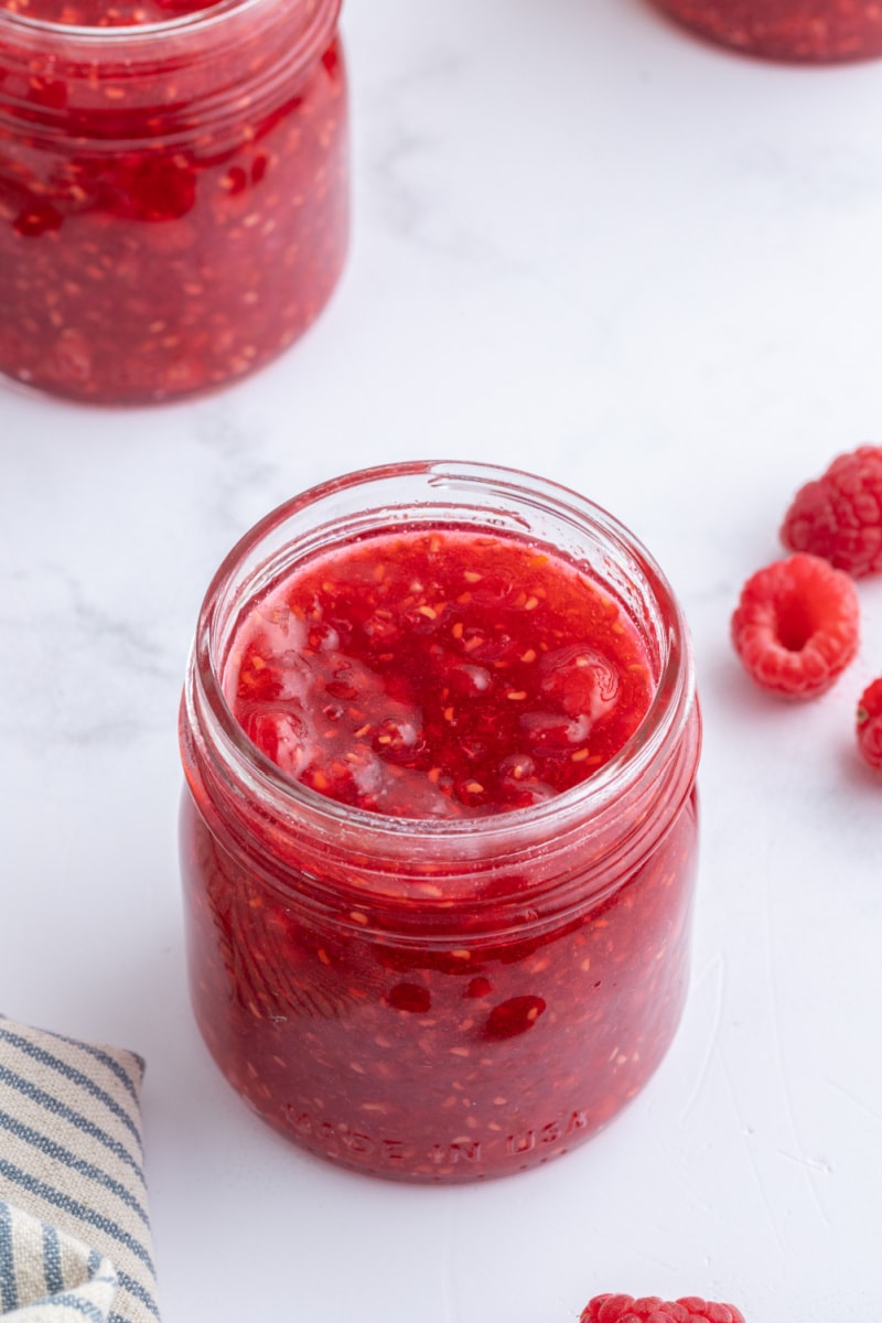 raspberry orange freezer jam in an open jar