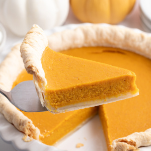 spatula taking slice of mom's pumpkin pie out of whole pie