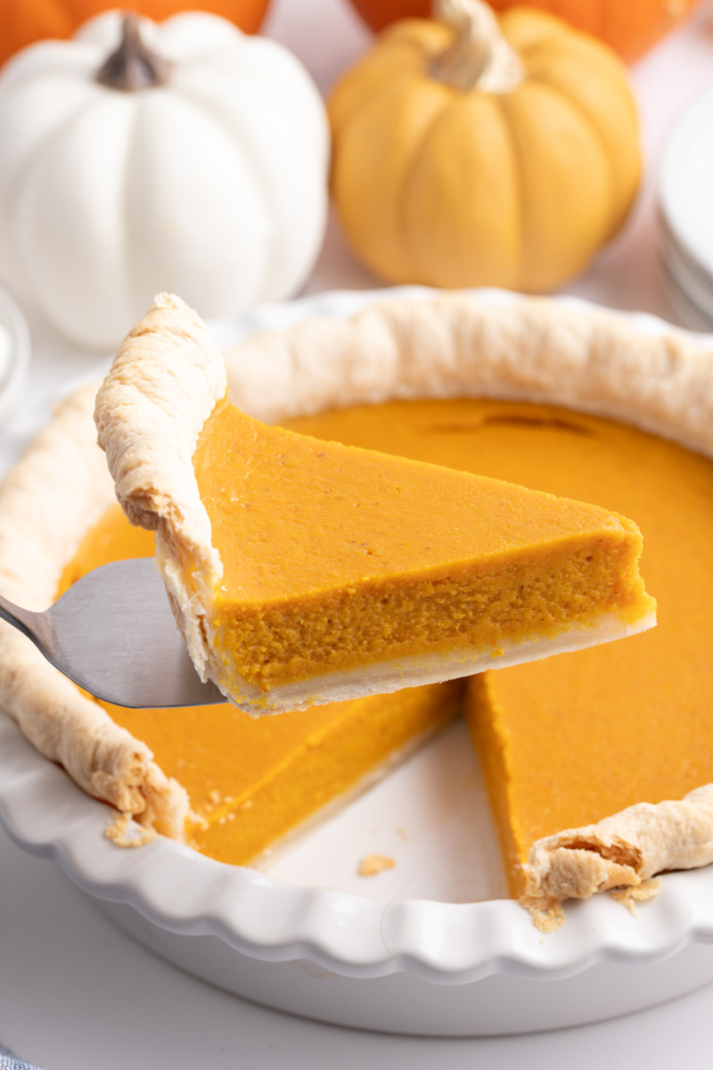 spatula taking slice of mom's pumpkin pie out of whole pie