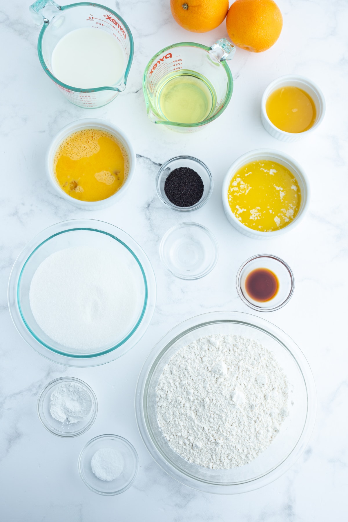 ingredients displayed for making almond orange poppy seed cake