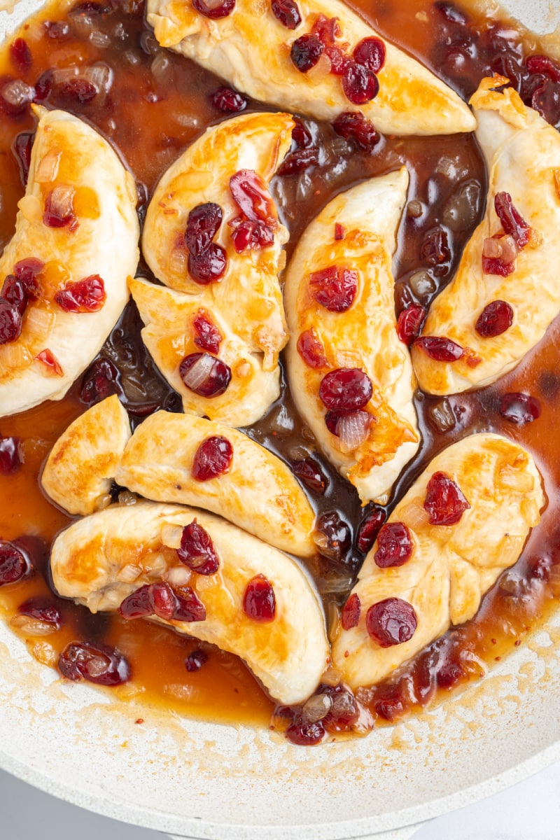 apricot cranberry chicken in a white skillet