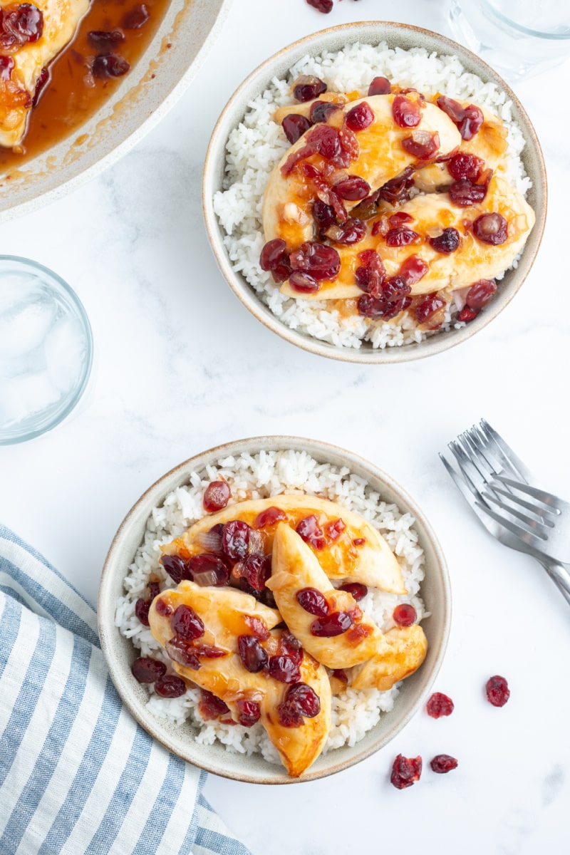 apricot cranberry chicken in bowls with rice