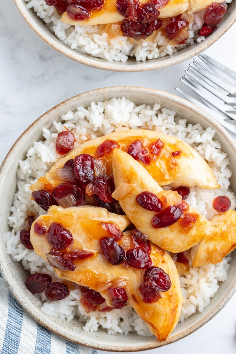 apricot cranberry chicken on plate over rice