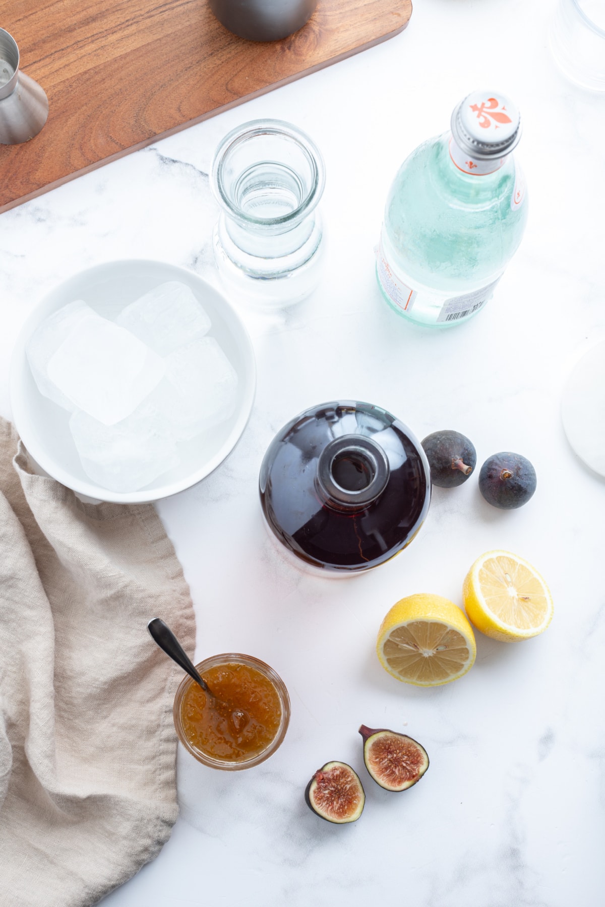 ingredients displayed for making a fig old fashioned