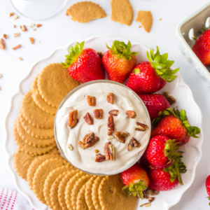 platter of kahlua dip surrounded by strawberries and cookies