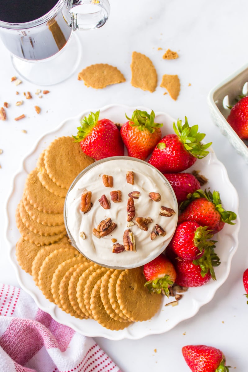 platter of kahlua dip surrounded by strawberries and cookies