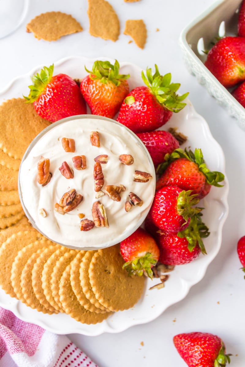 kahlua dip surrounded by strawberries and cookies on platter