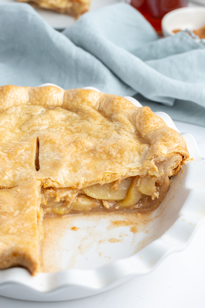 maple apple pie with big slice taken out