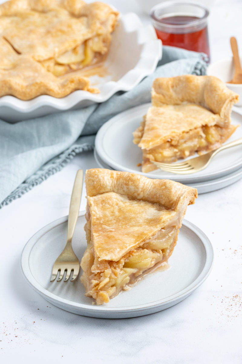 two slices of maple apple pie on plates