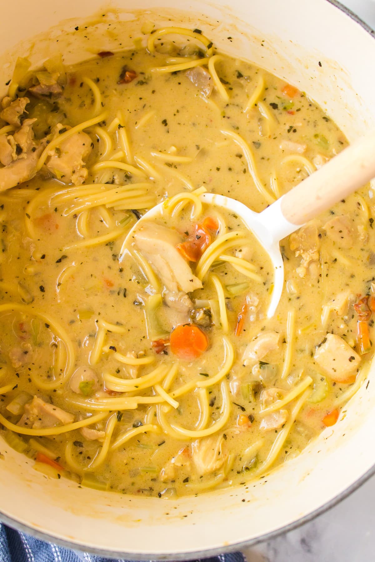 ladle of chicken alfredo soup out of pot