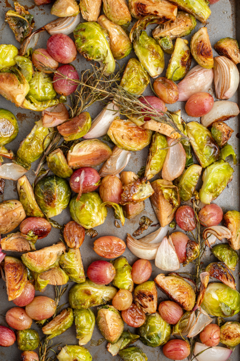 sheet pan of balsamic brussels sprouts with grapes and shallots