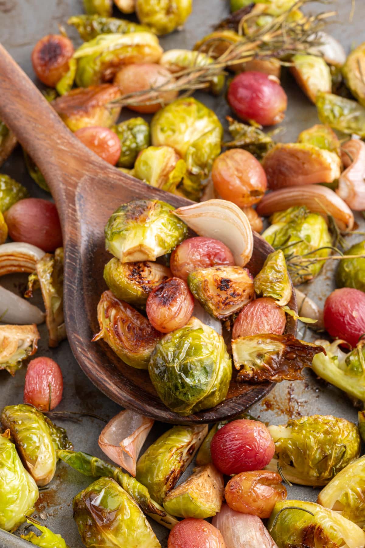 spooning out sheet pan balsamic brussels sprouts