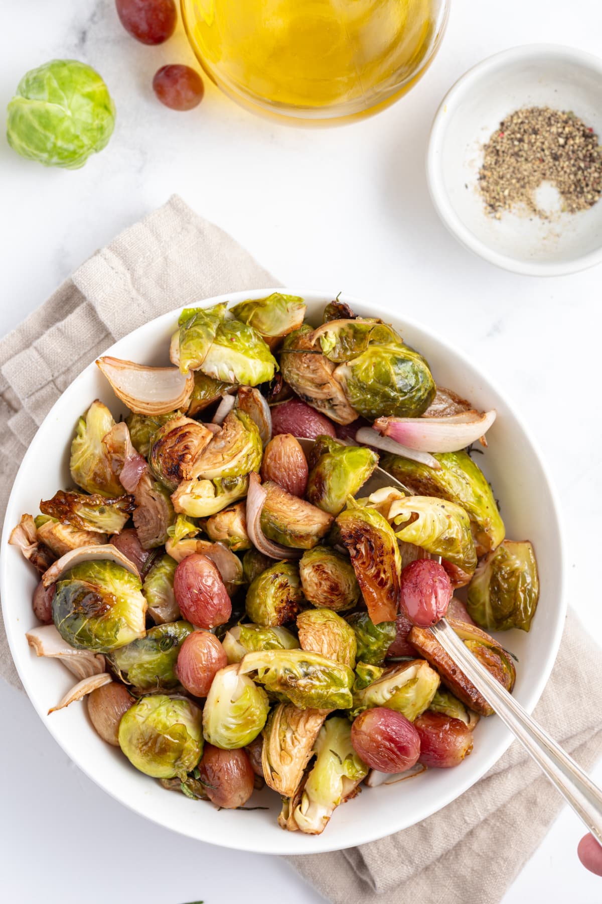 bowl of sheet pan balsamic brussels sprouts with grapes and shallots