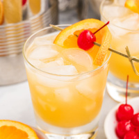 whiskey sour in a cocktail glass with garnishes