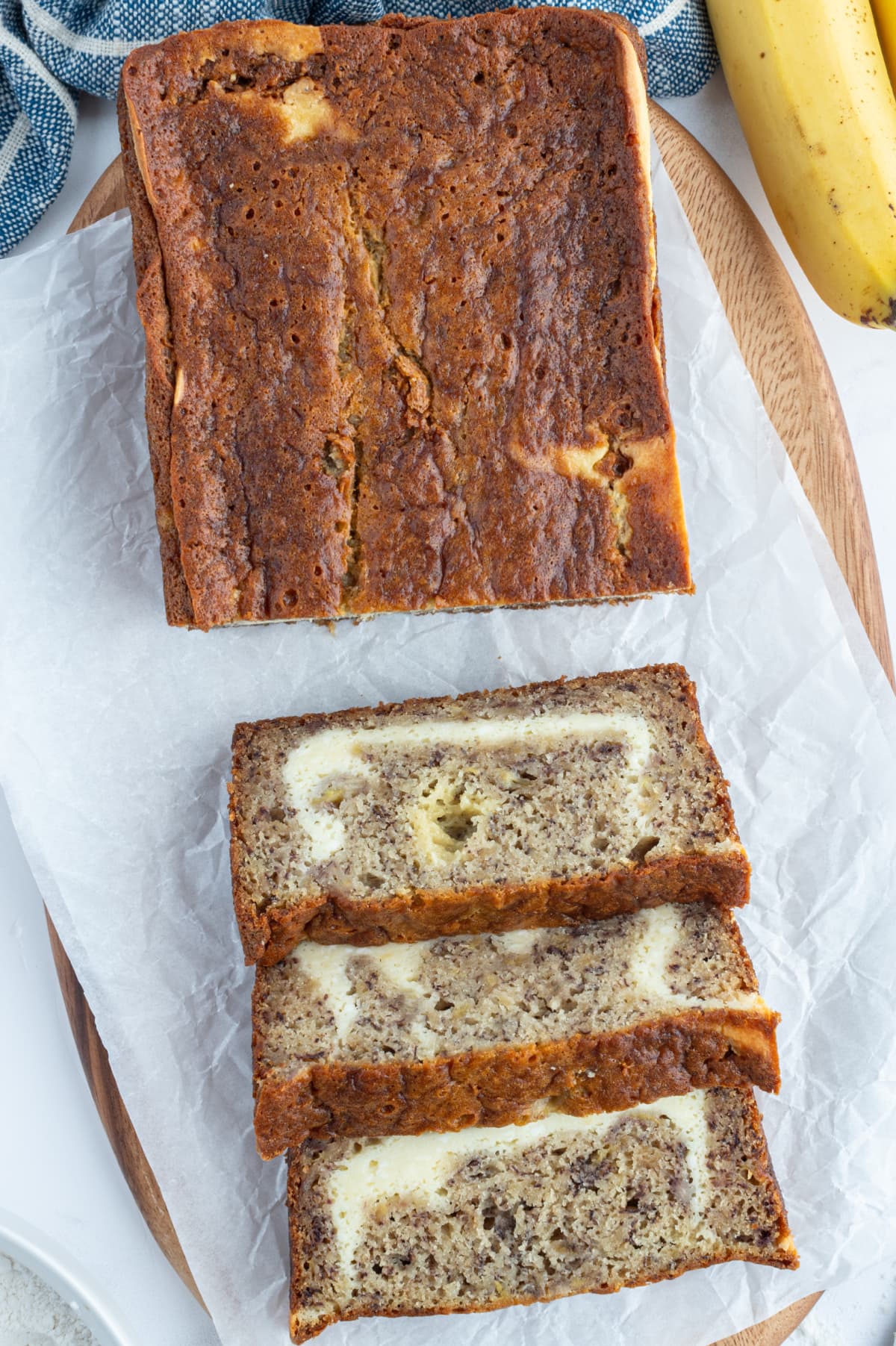 loaf of cheesecake banana bread with some sliced