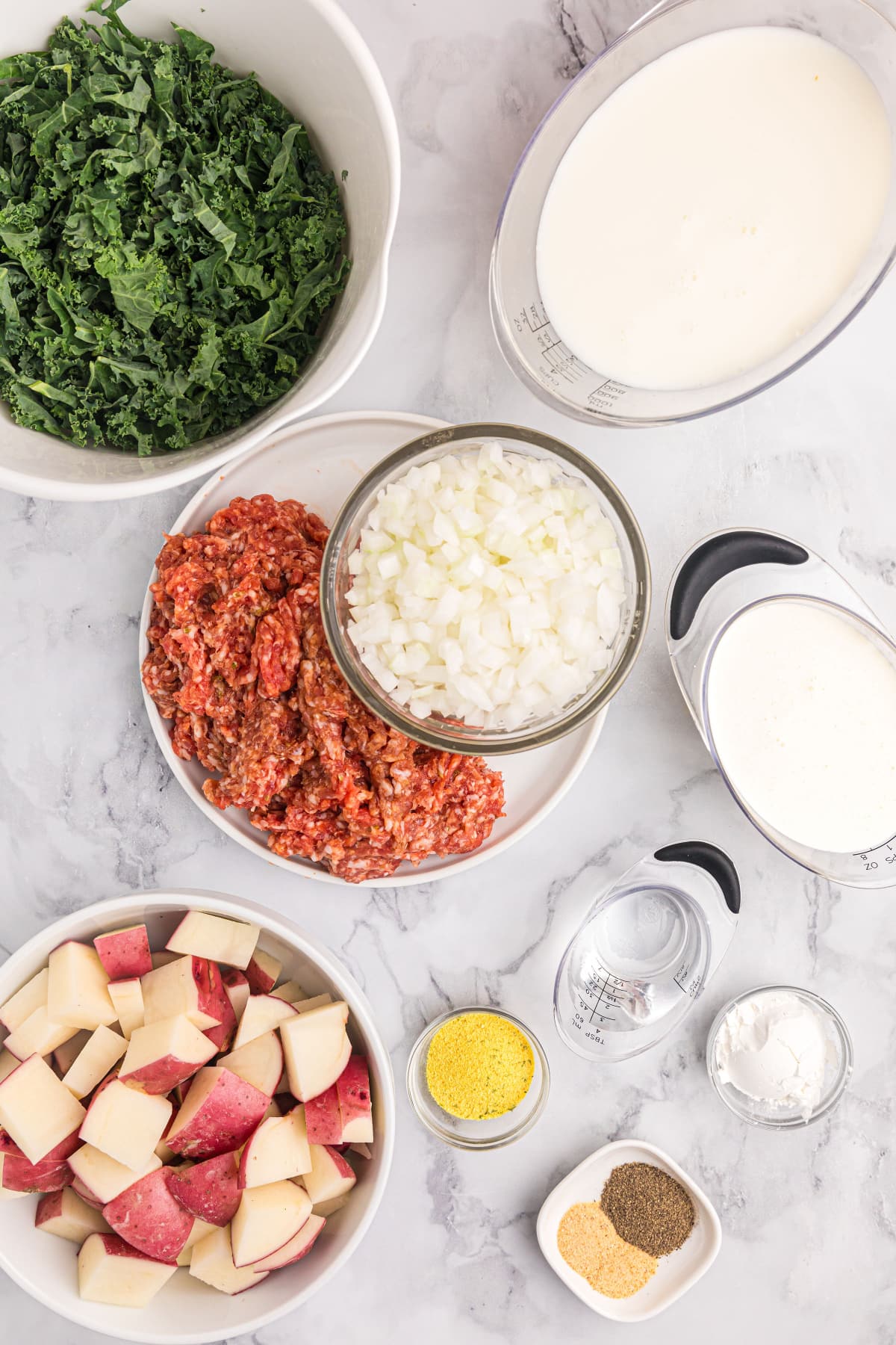 ingredients displayed for making potato sausage and kale soup