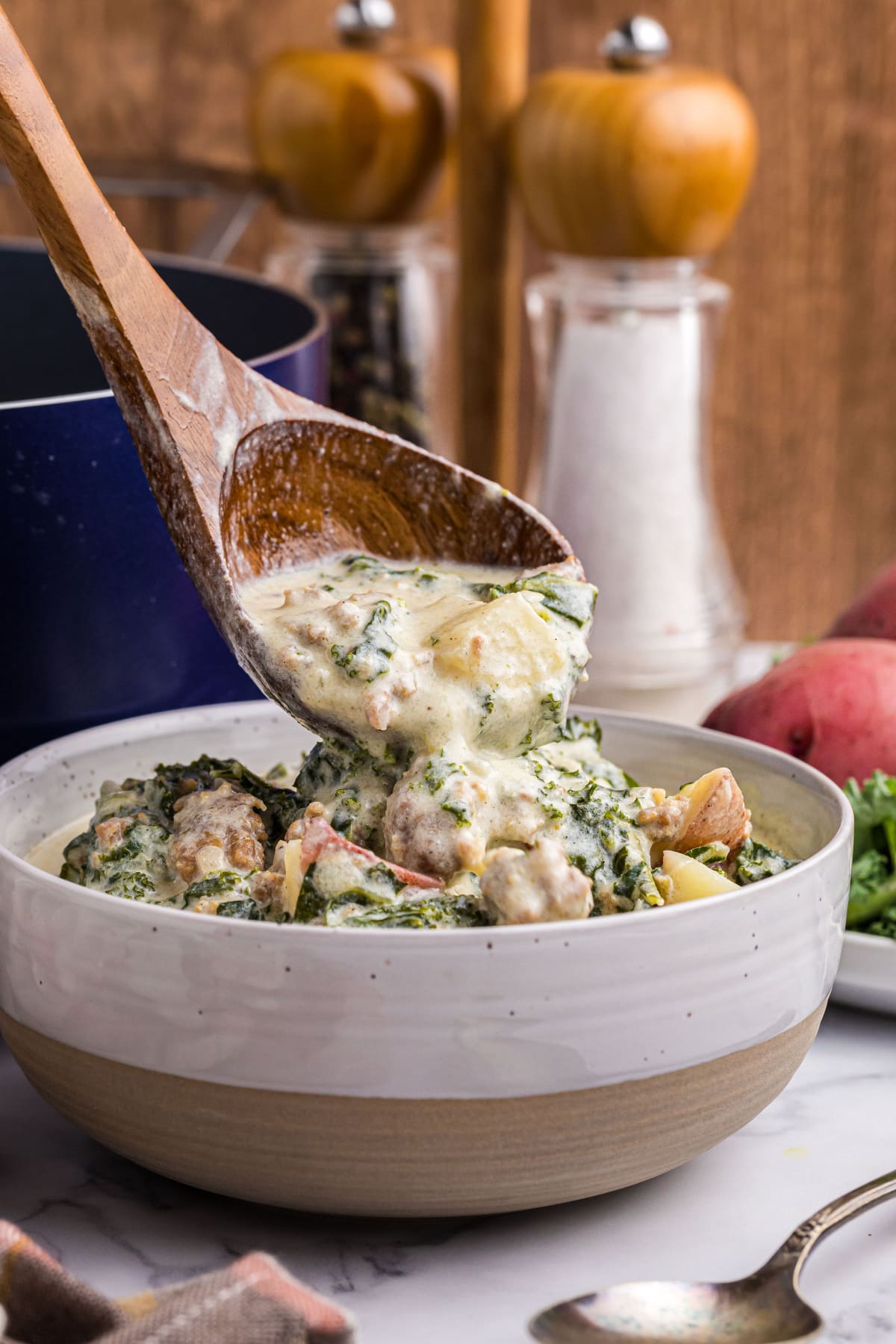 spooning soup into soup bowl