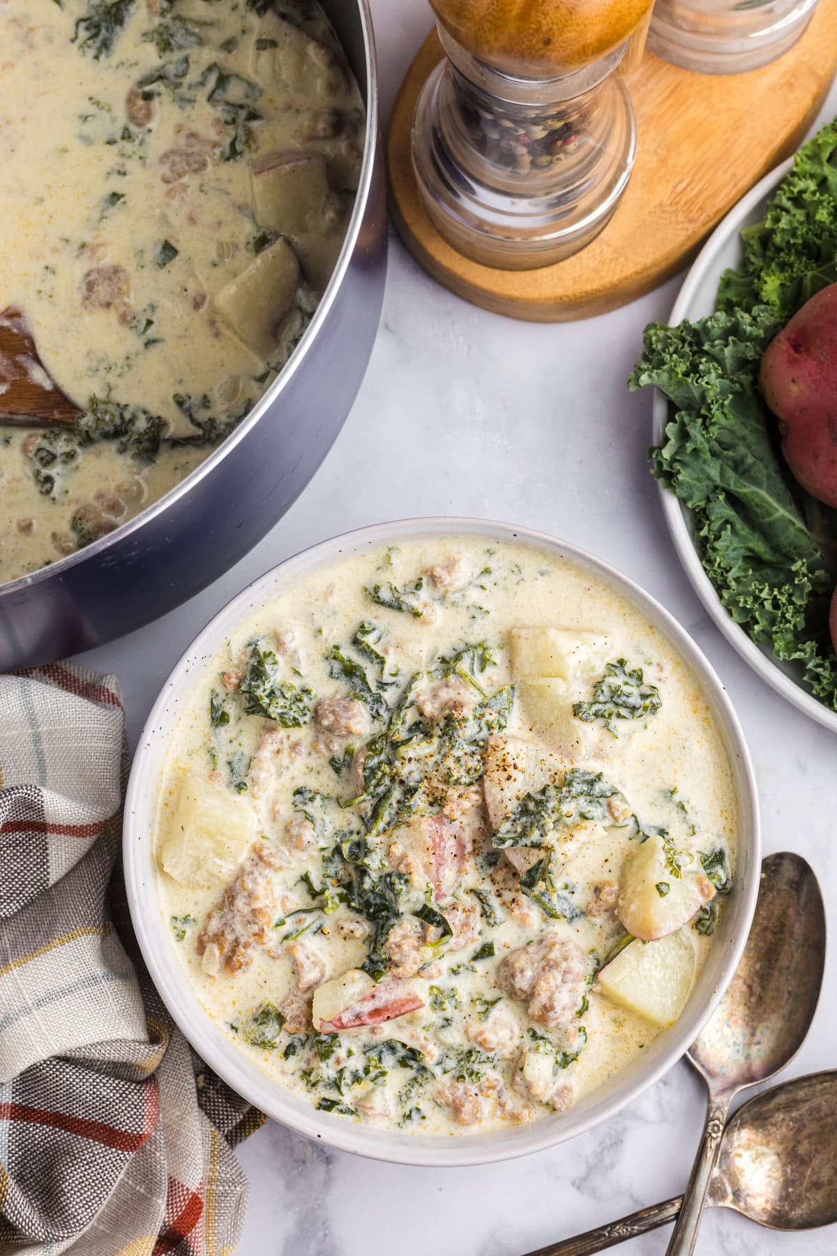 overhead shot of potato sausage and kale soup in bowl