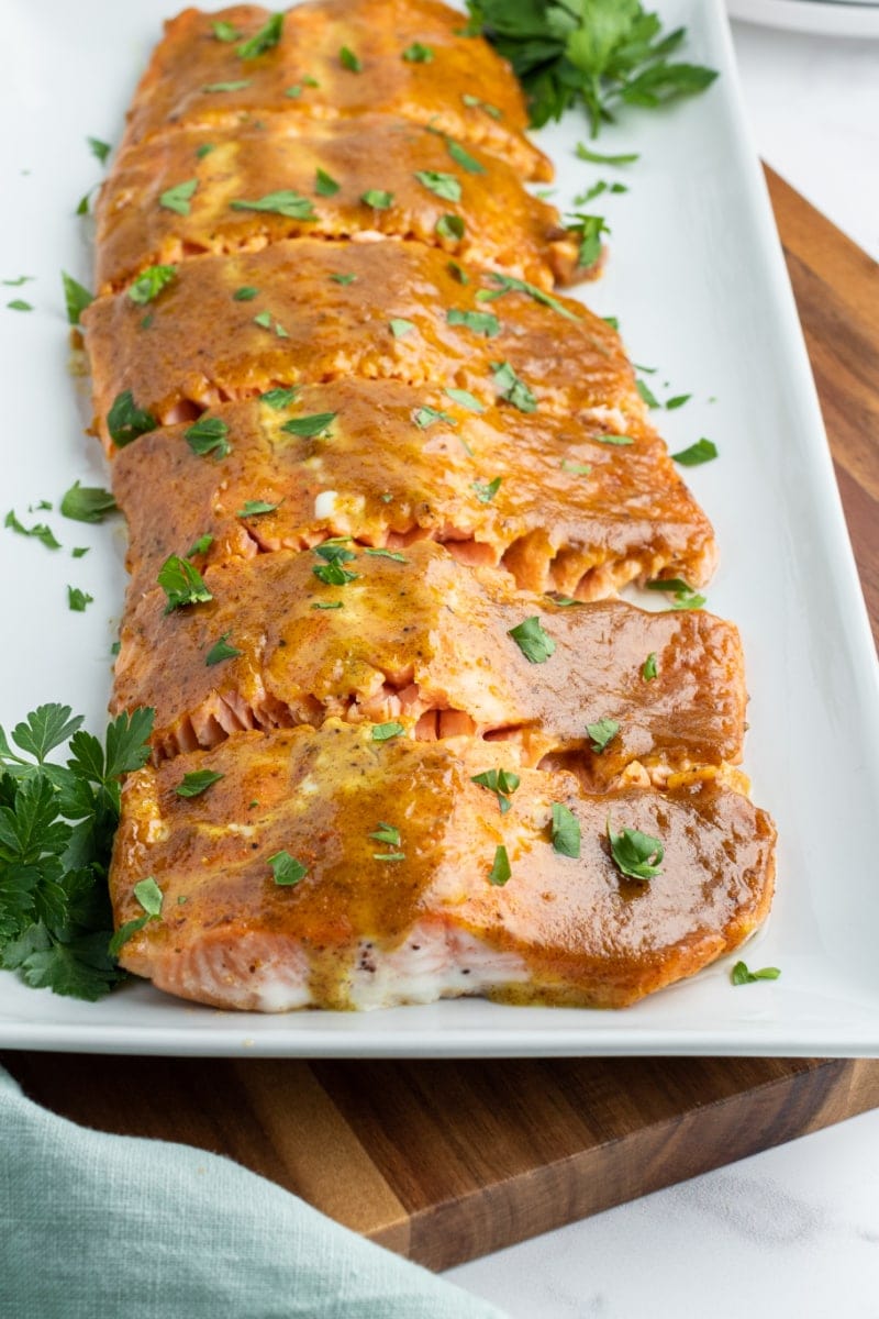 salmon with mustard and brown sugar sliced on platter