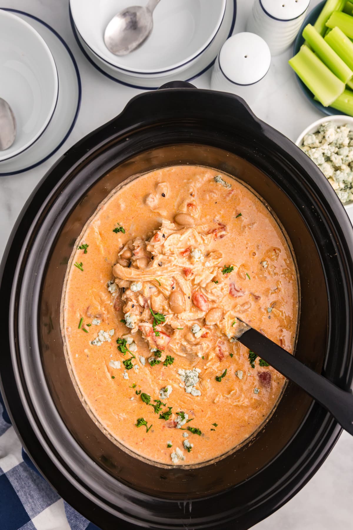 overhead shot of buffalo chicken soup in slow cooker insert