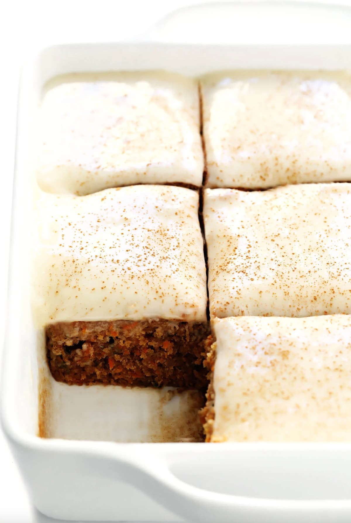 pan of carrot cake bars with one slice taken out