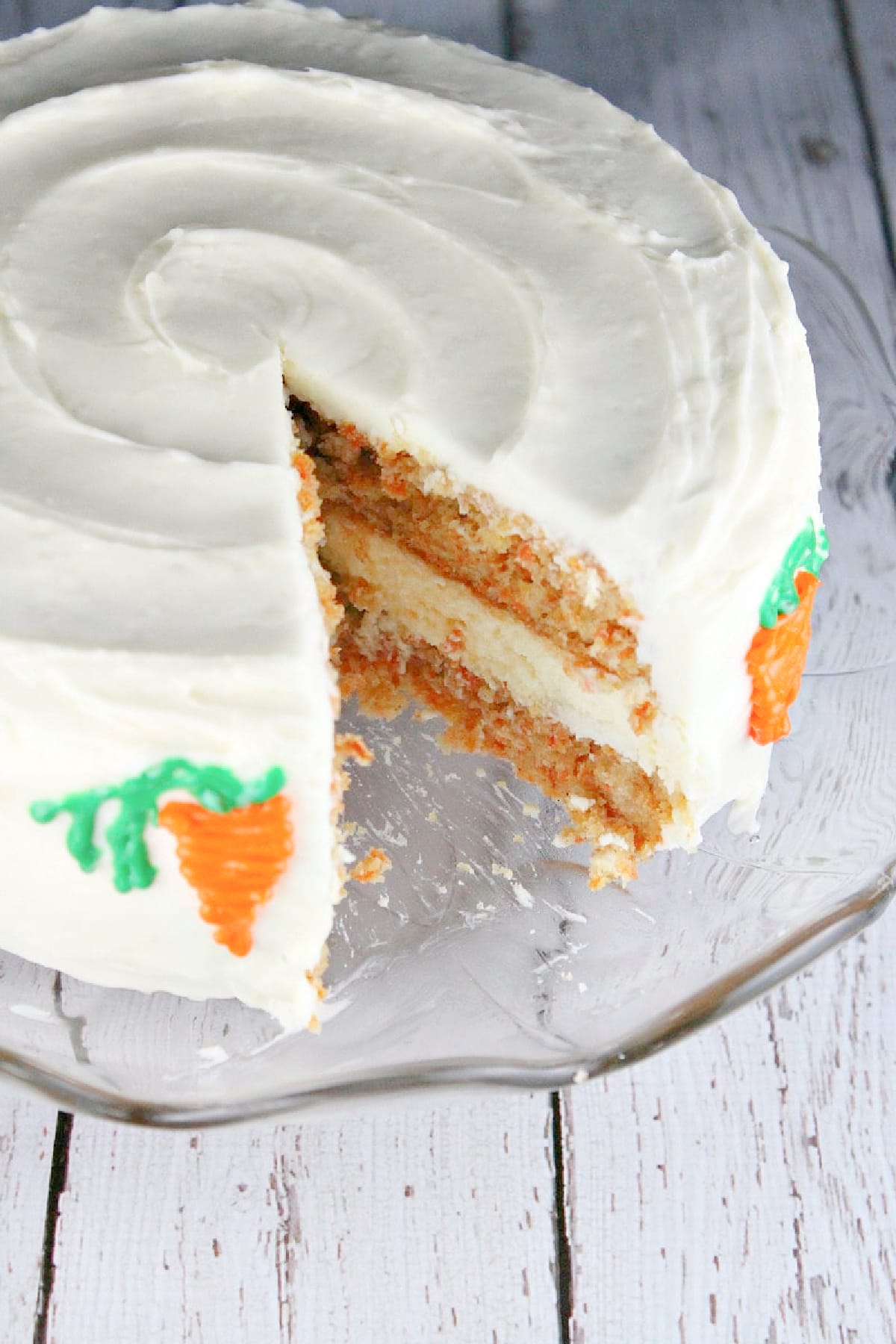 carrot cake cheesecake cake with slice taken out