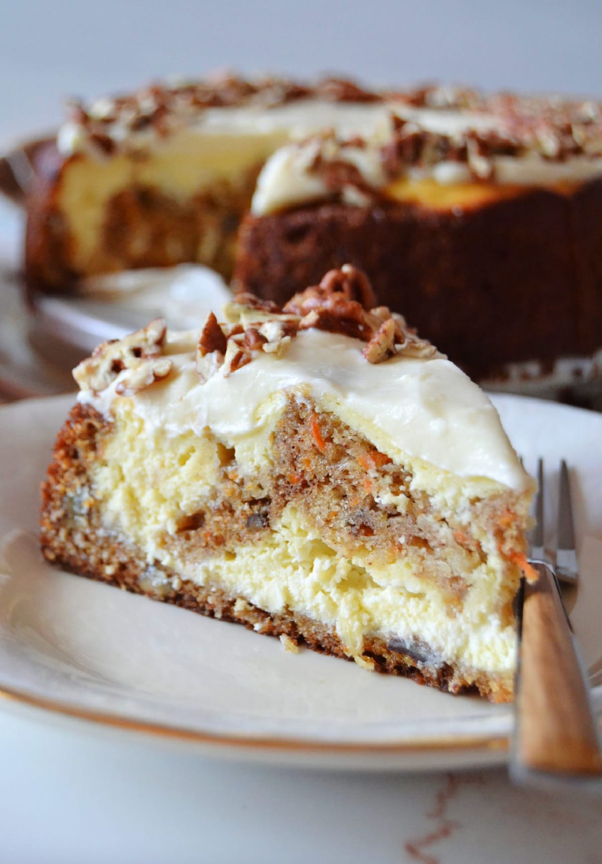 slice of carrot cake cheesecake on plate