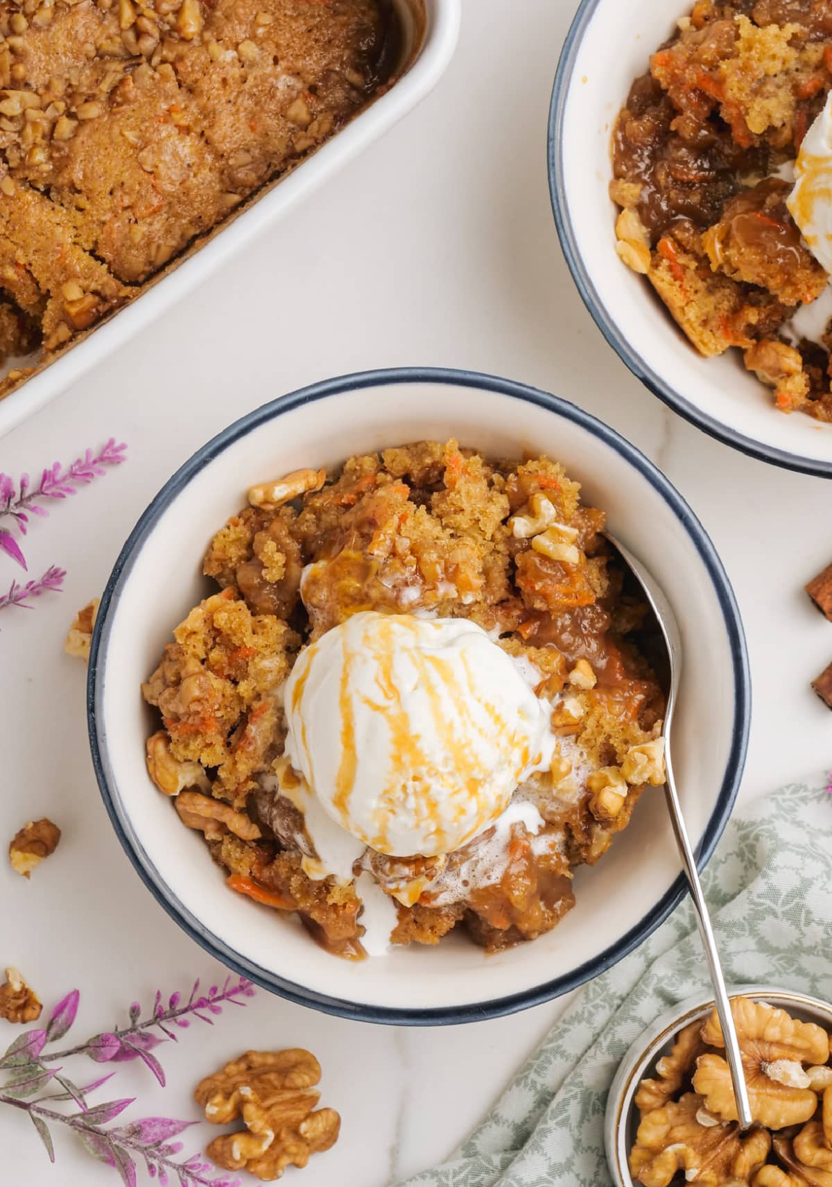 carrot cake cobbler in serving dish with ice cream