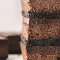 three chocolate cheesecake bars stacked