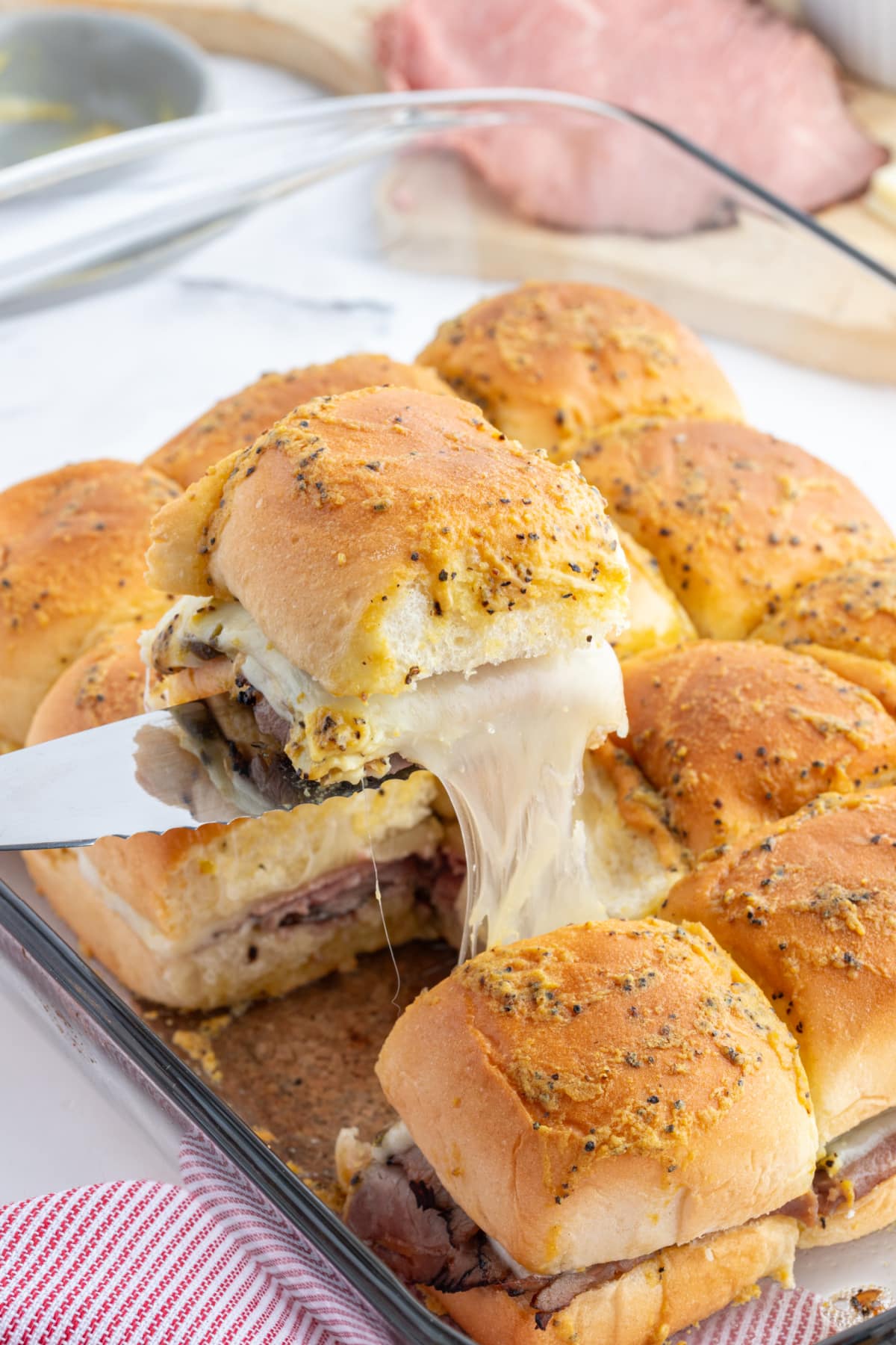 spatula taking cheesy sandwich out of bunch