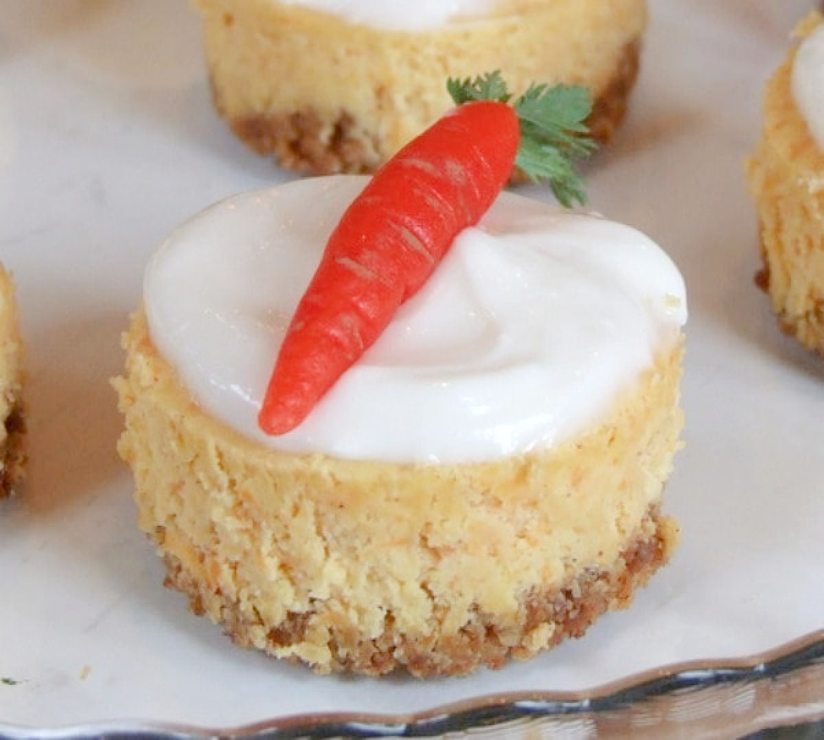 mini carrot cake cheesecake with marzipan carrot on top