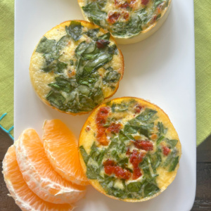 vegetarian egg bites on a plate with orange slices