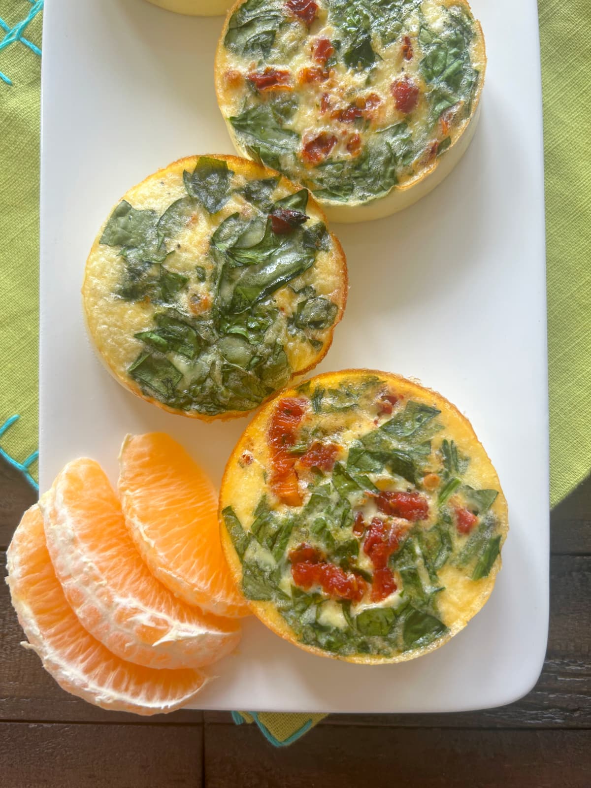 vegetarian egg bites on a plate with orange slices