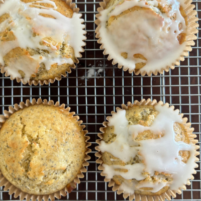 lemon poppy seed muffins on baking rack with some of them topped with glaze