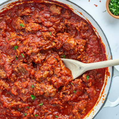 easy meat sauce in a pan with a wooden spoon
