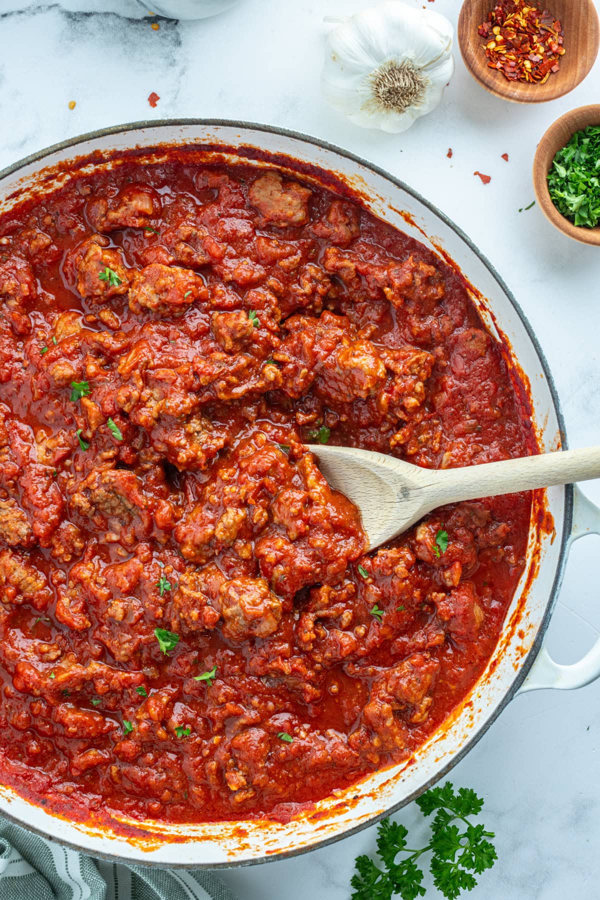 easy meat sauce in a pan with a wooden spoon