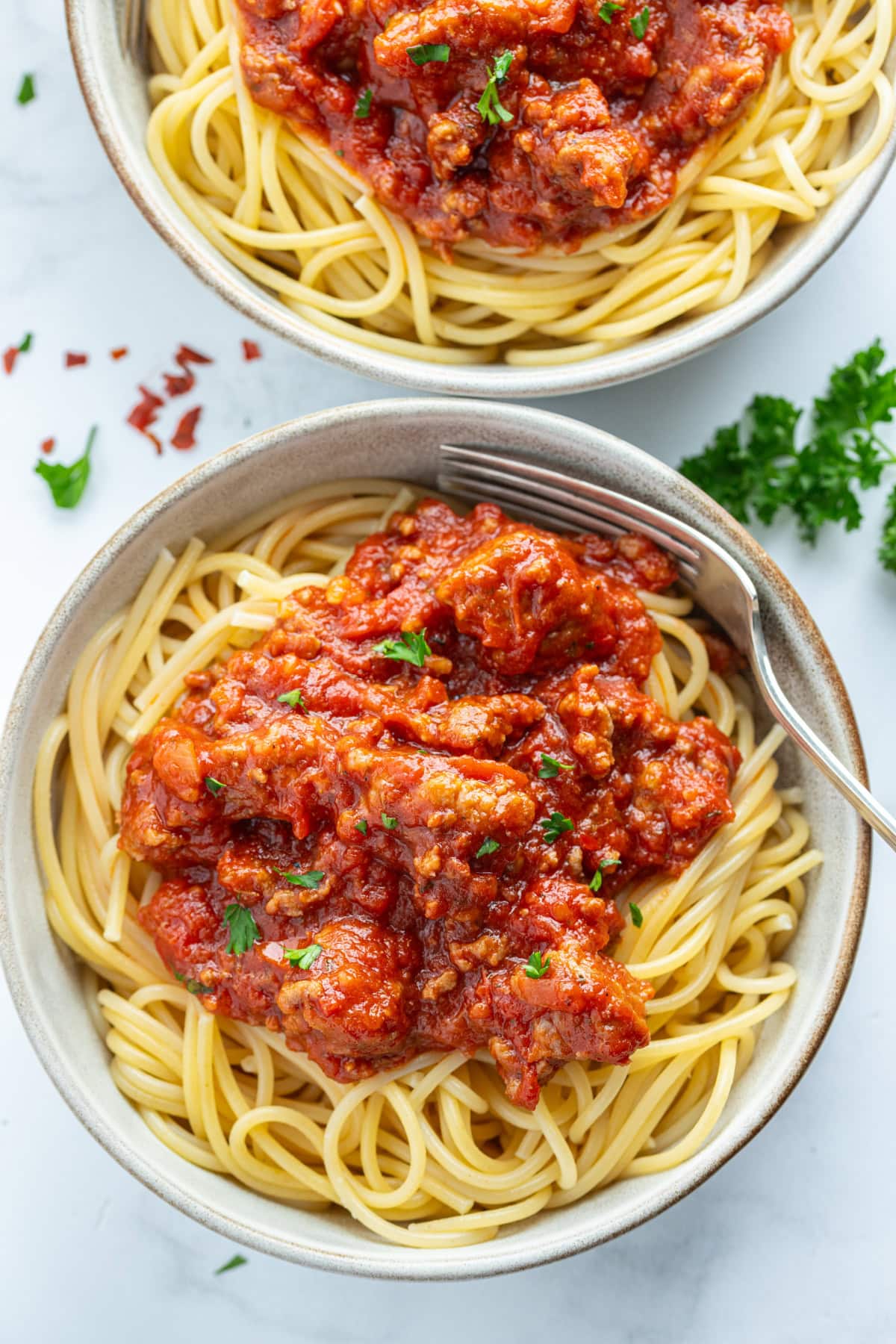 spaghetti topped with meat sauce in bowl