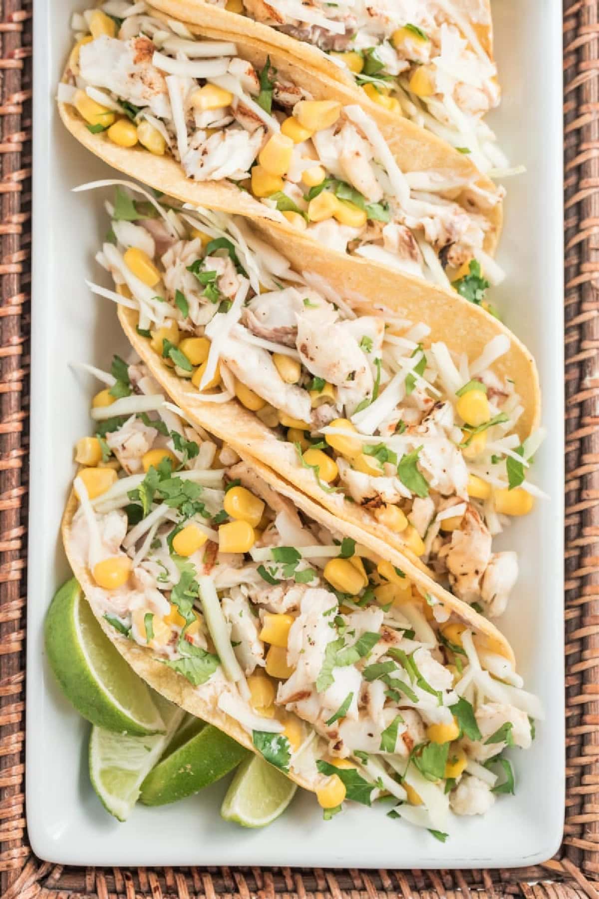 several fish tacos with chipotle cream on platter