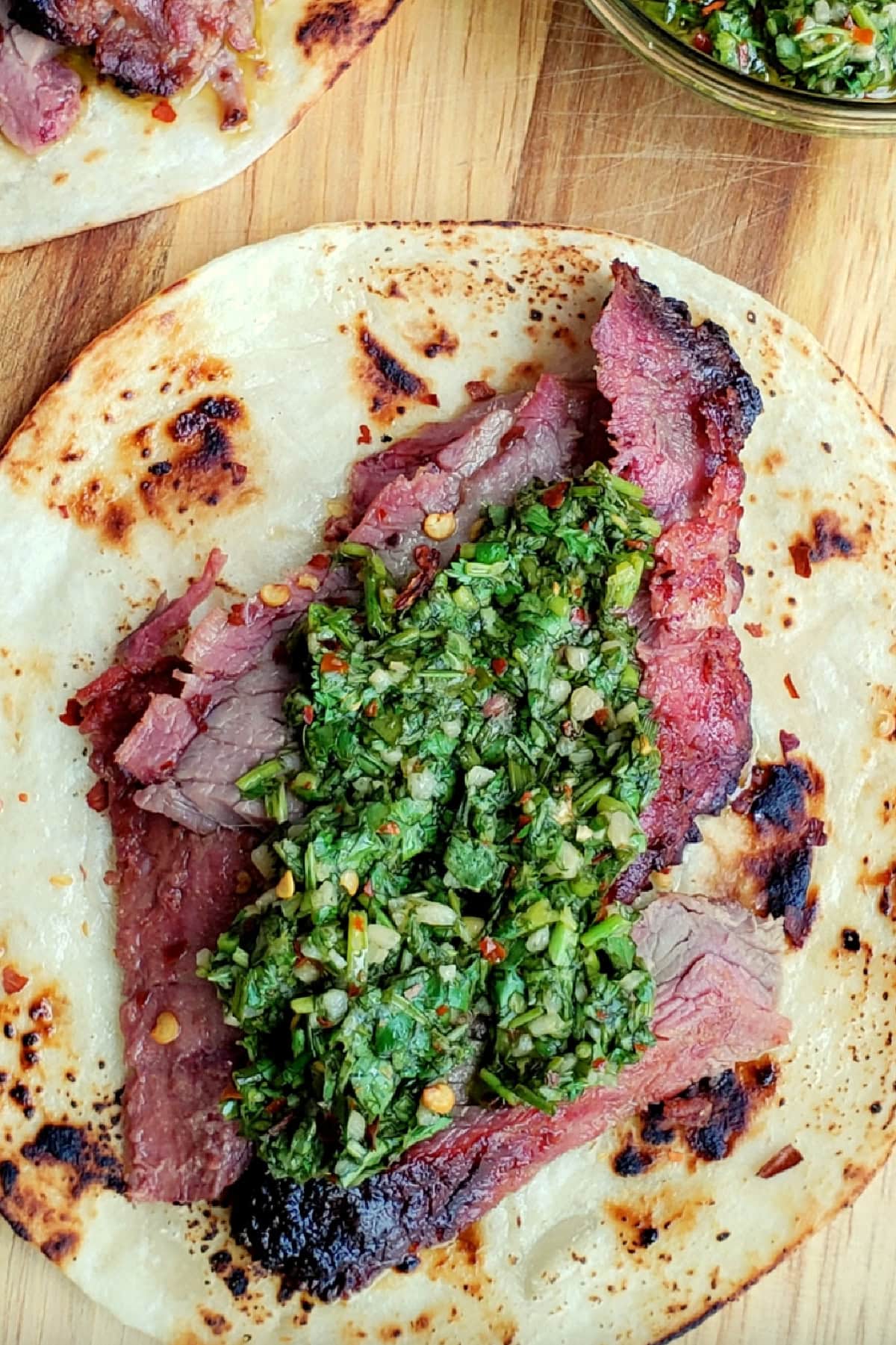 one open faced flank steak taco with chimichurri