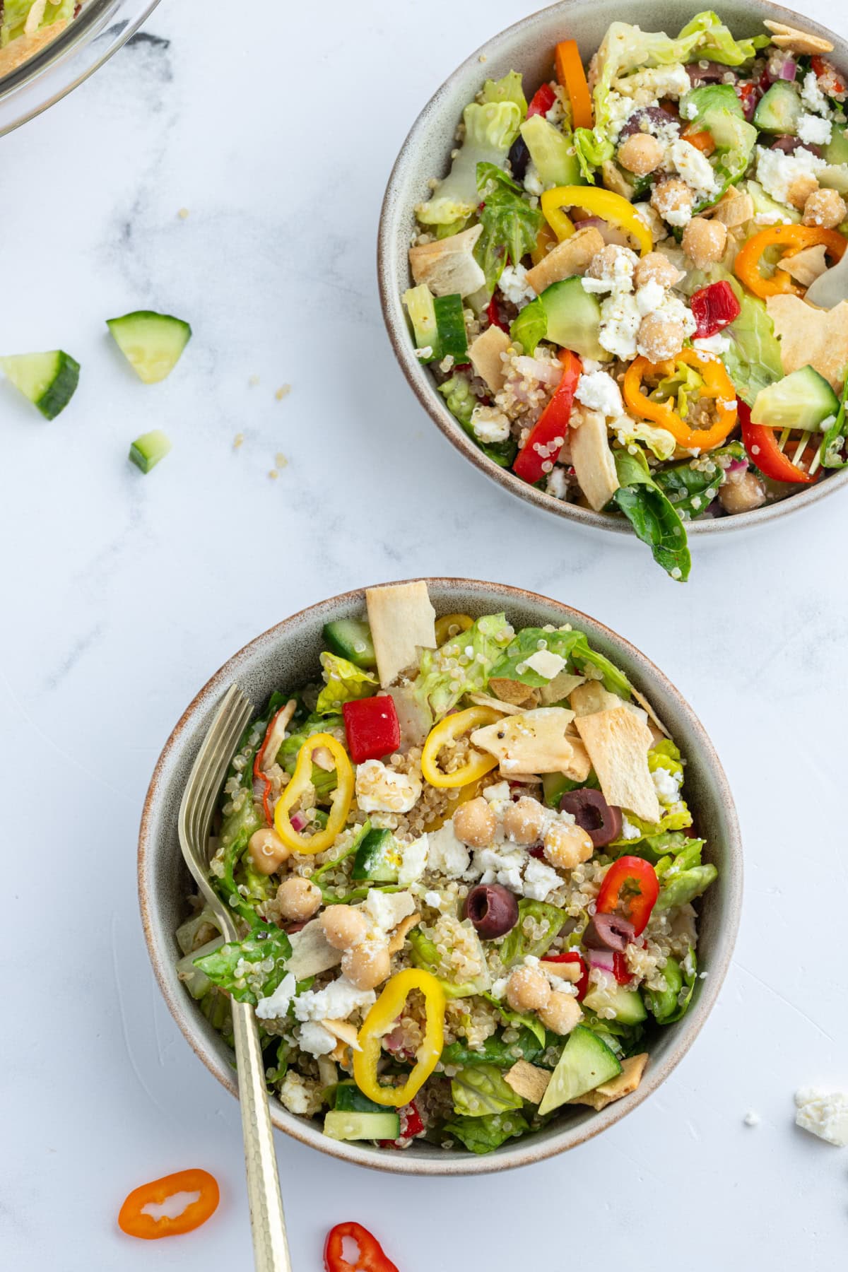 Greek Quinoa Chopped Salad recipe from RecipeGirl.com two bowls of greek quinoa chopped salad