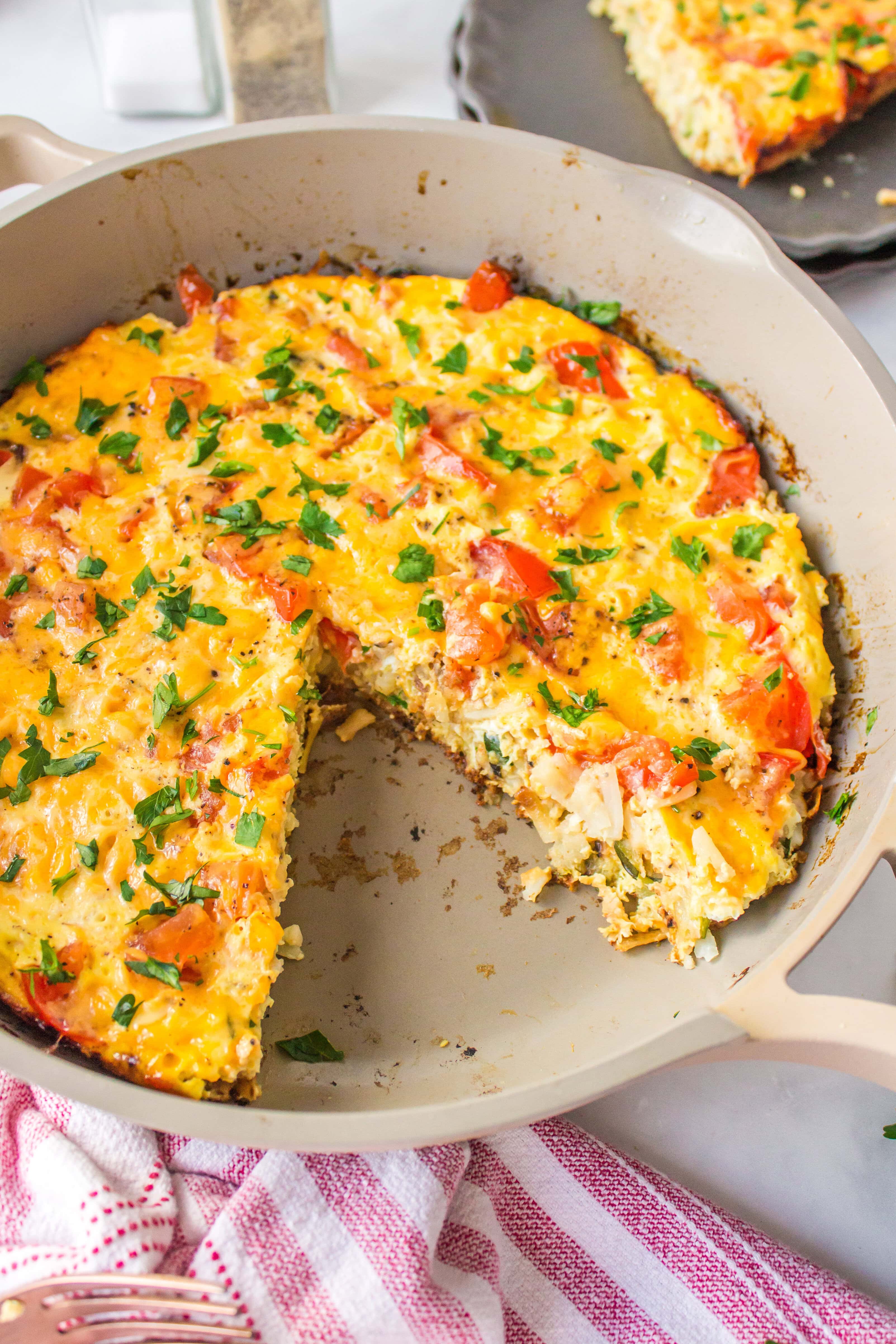 Hash Brown Frittata recipe from RecipeGirl.com hash brown frittata in pan with slice taken out