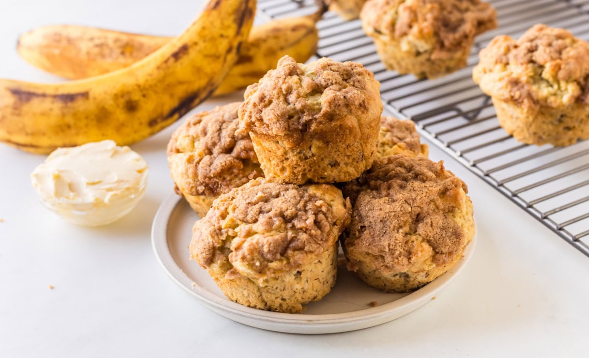 Gluten Free Banana Muffins that are soft, moist and topped with a sweet crumble. Easy to make and so good you’d never know they’re gluten-free! plate of gluten free banana muffins