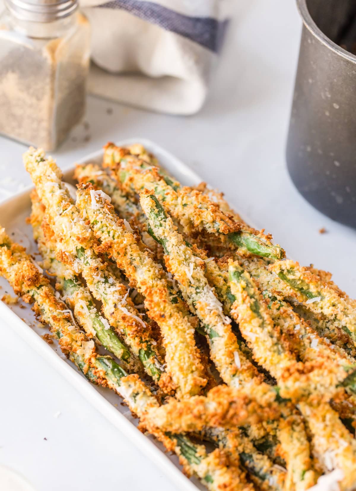 air fryer fried green beans on white platter