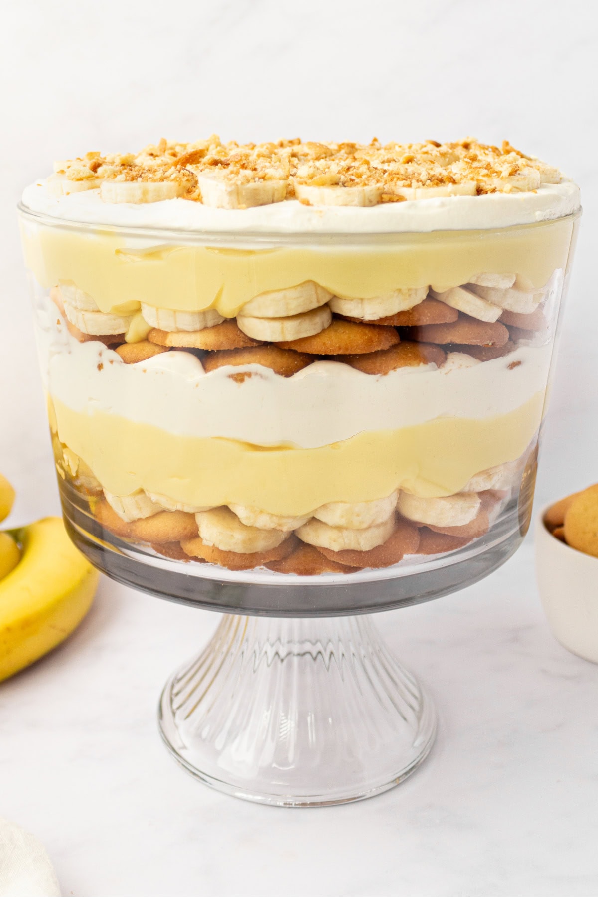 This Banana Pudding Trifle is the ultimate crowd-pleasing dessert! Layers of banana pudding, cheesecake whipped cream, fresh bananas, and Nilla wafers—easy and no bake! banana pudding trifle in trifle dish